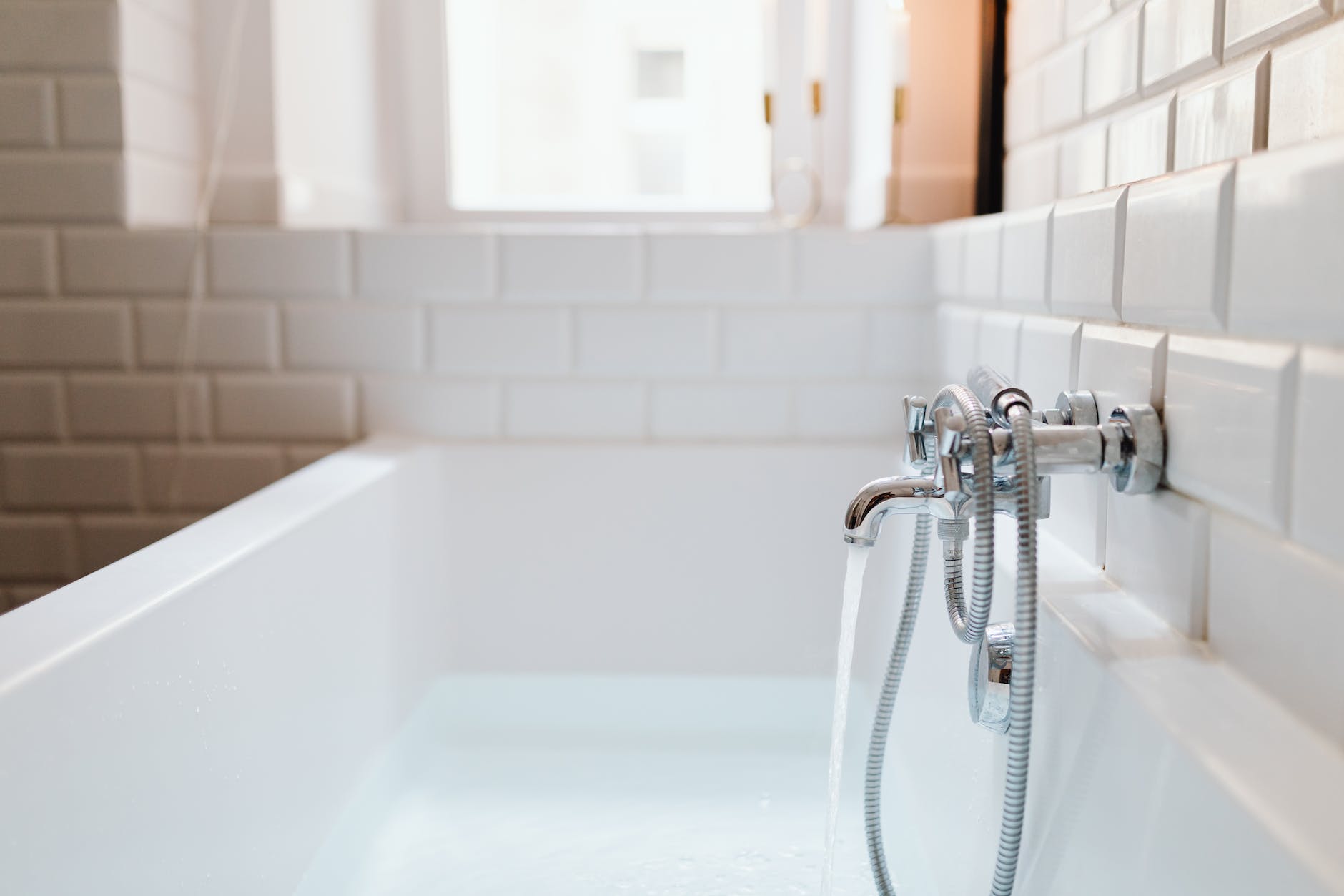 stainless steel faucet mounted on ceramic tiles