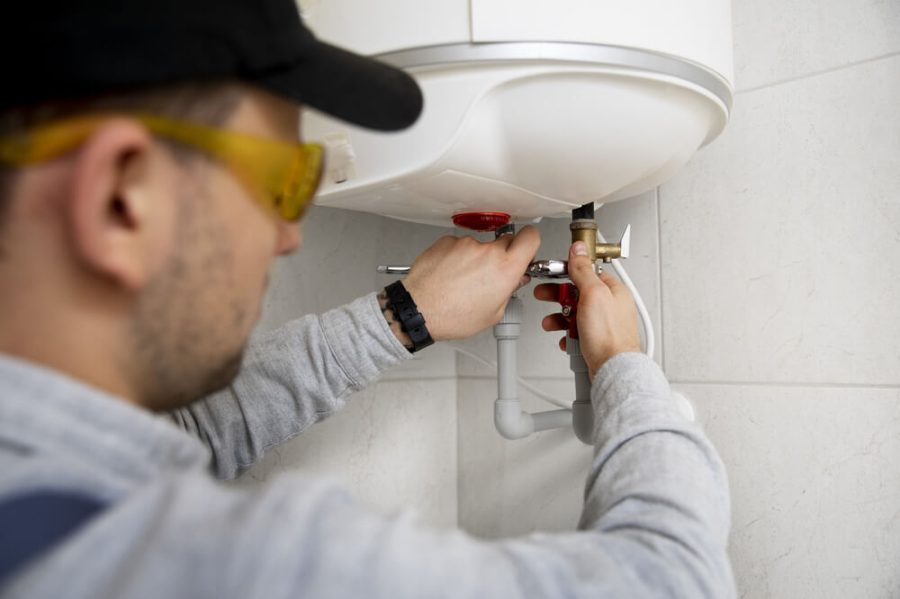 worker-repairs-water-heater